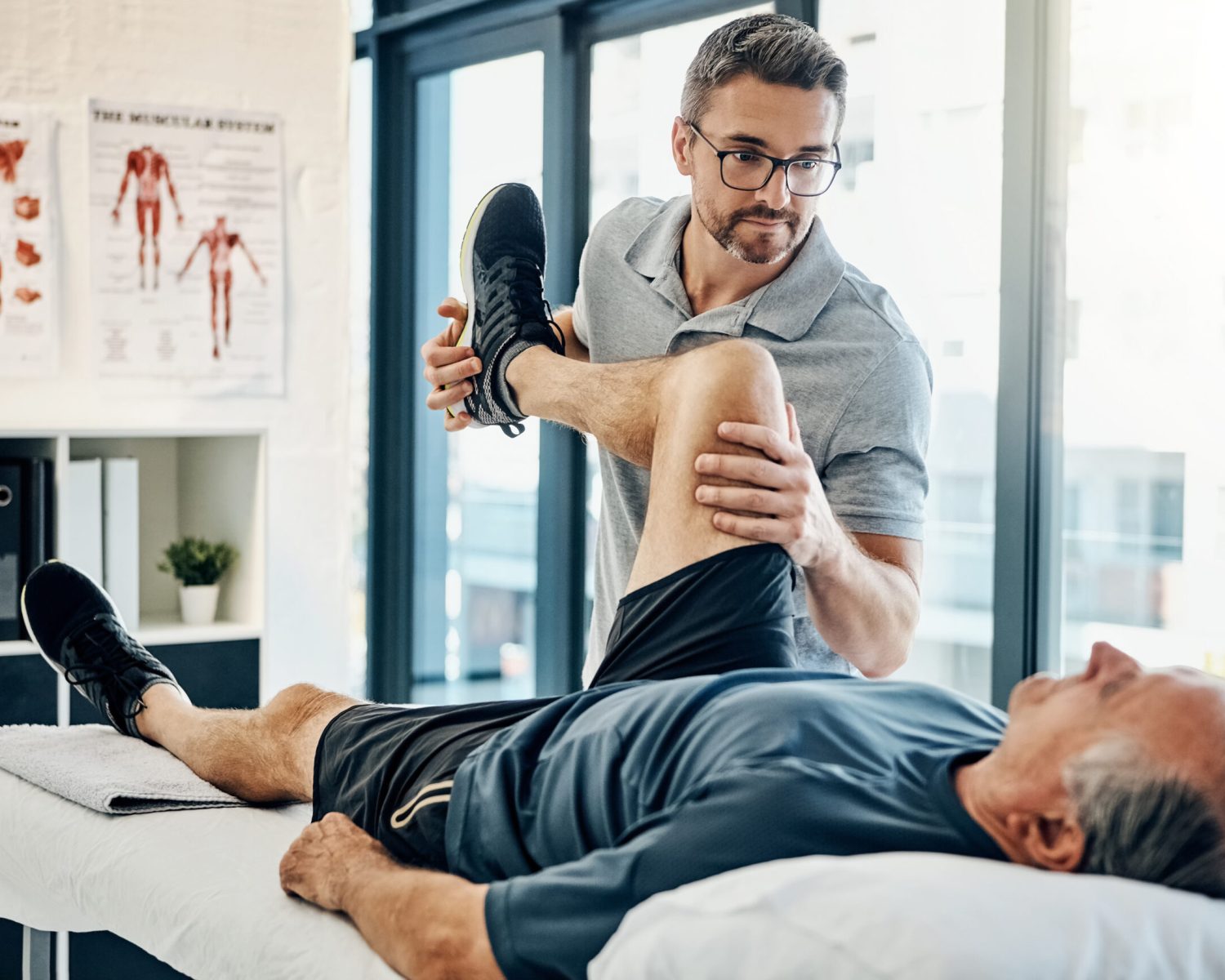 Shot of a friendly physiotherapist treating his mature patient in a rehabilitation center